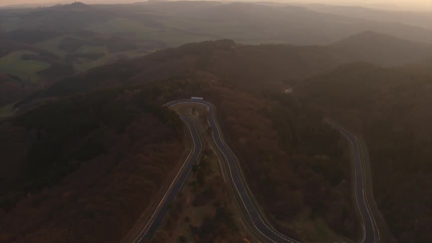 A race course is being filmed high up by a drone