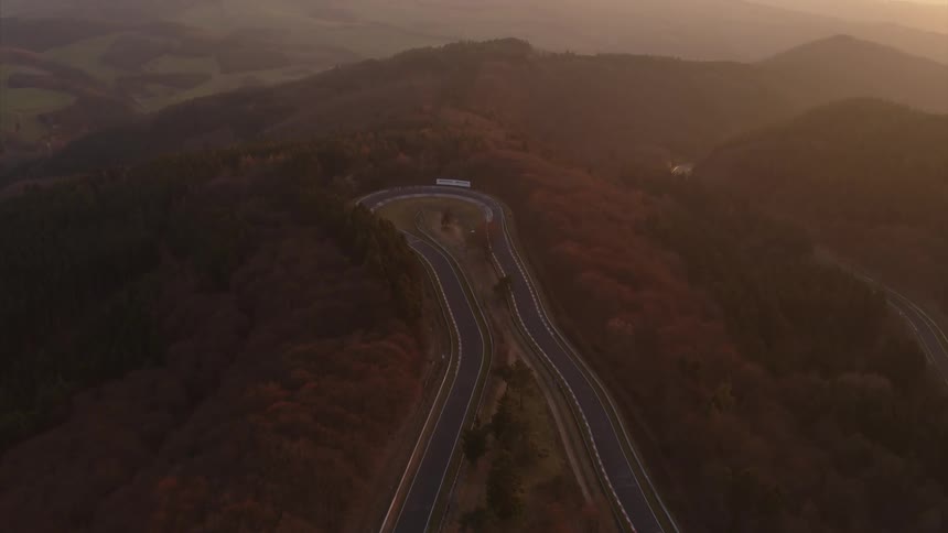 A winding road driving track is set up in the hills