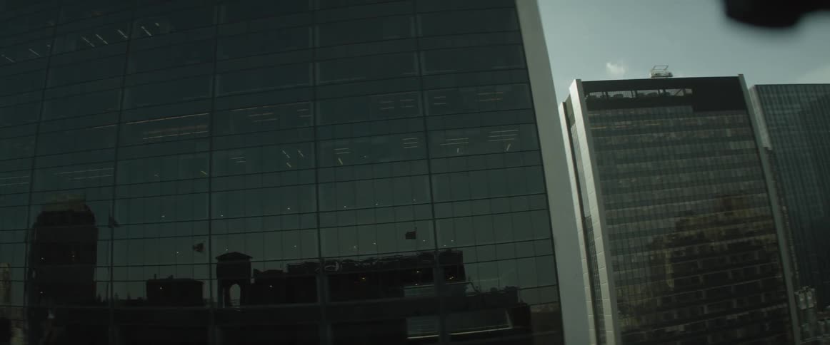 The city skyline is being filmed from the balcony of another building