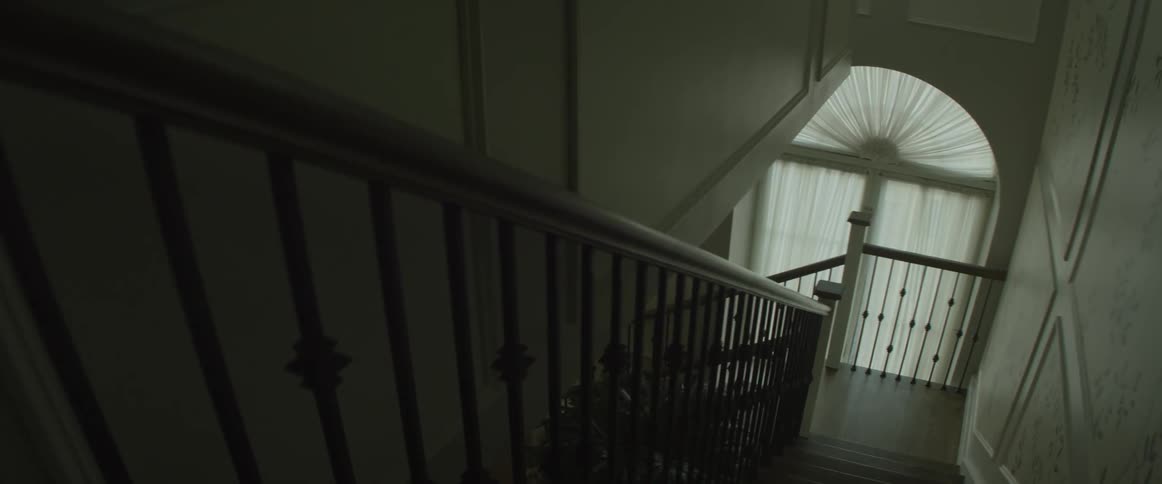 An empty house and staircase is filmed