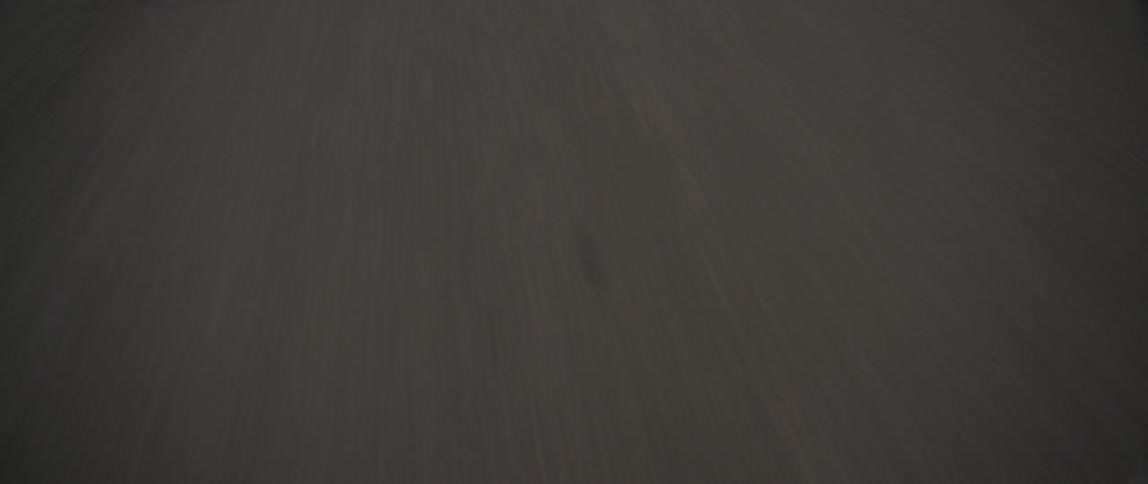 The street is being filmed close up while traveling fast