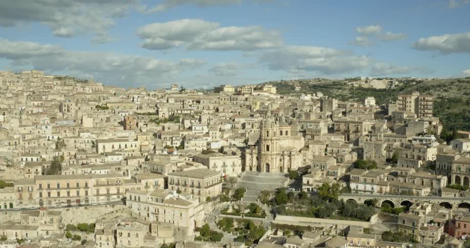 A cathedral sits amidst an old city on a hillside