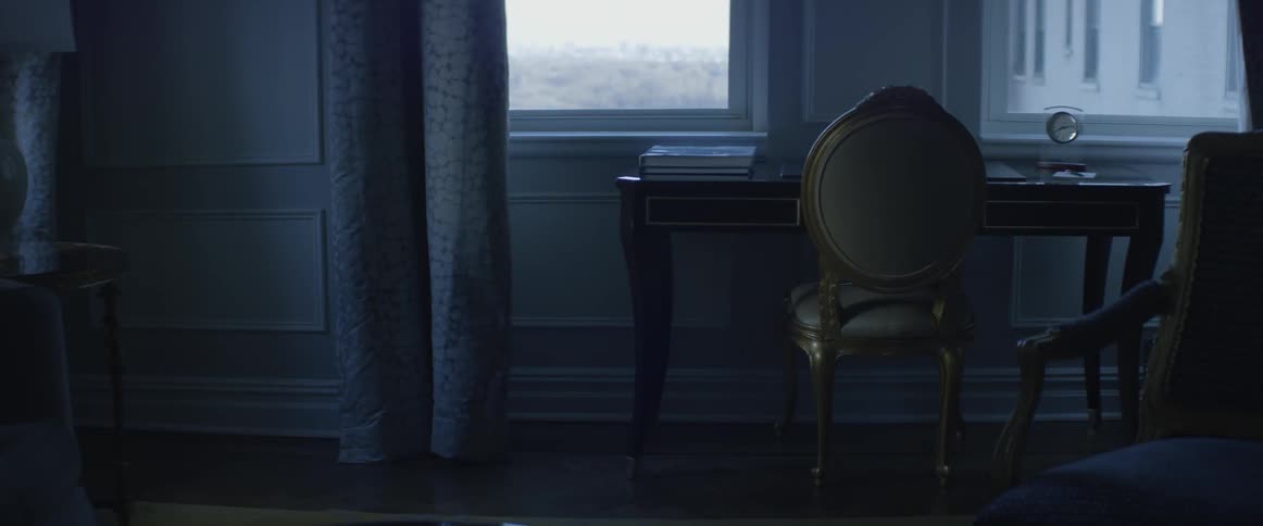 A chair is sitting at a desk in front of a window