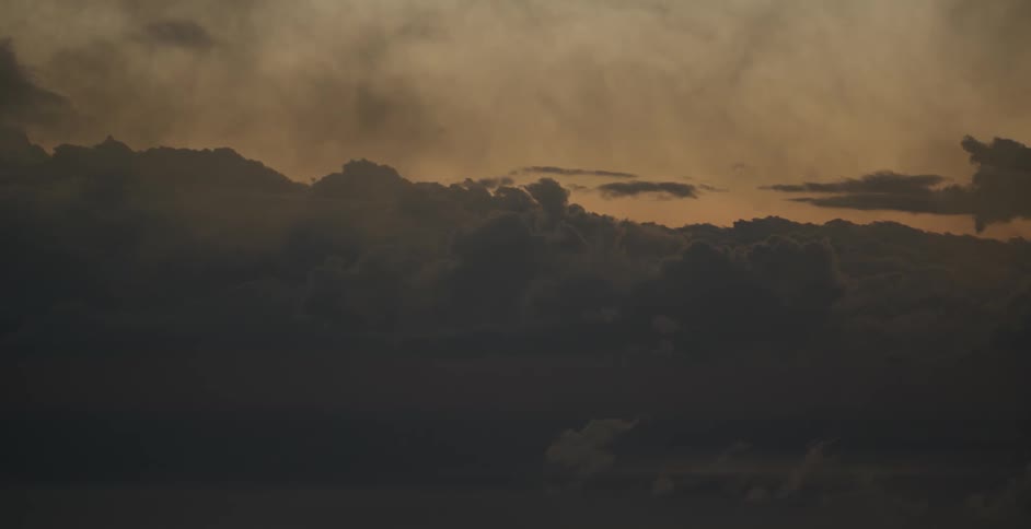 Mountains are filmed in the distance at sunset