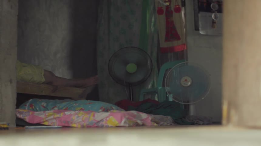 A person is lying inside of their shack