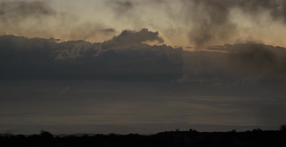 Dark clouds float over the land