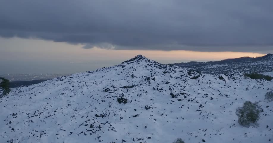 Snow covered mountains under a cloudy sky