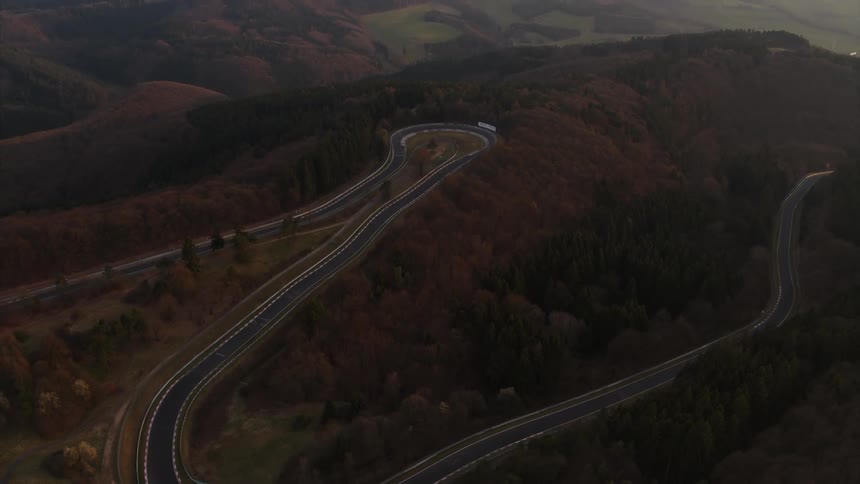 A car race course is filmed from a drone