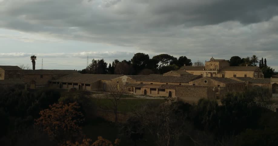 A group of buildings in an old town are being filmed from a drone