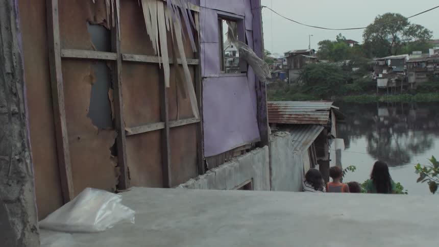 A torn up village and people are filmed