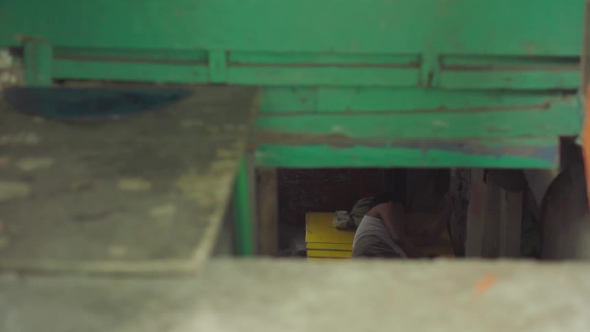 A person sleeps on a yellow mat