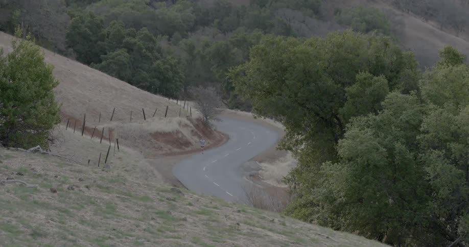 A person is running on a lonely road
