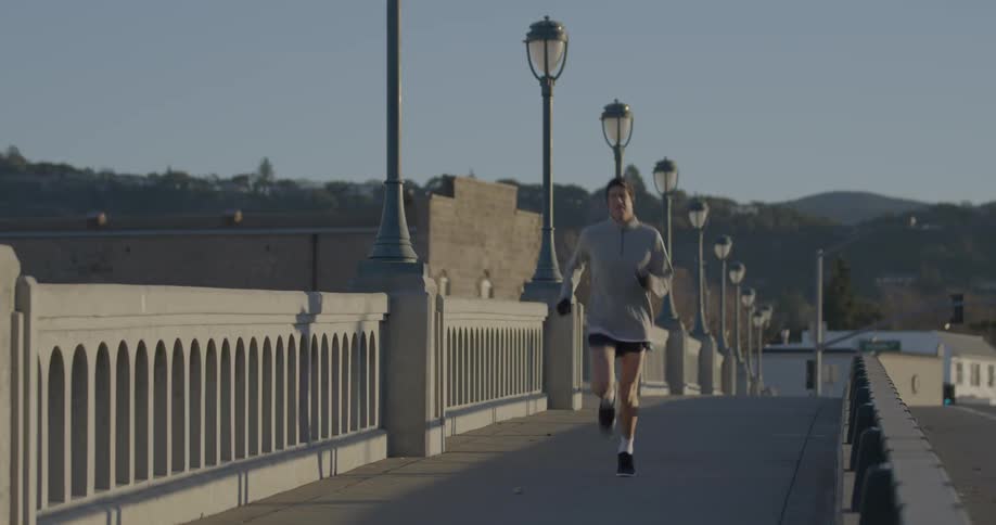 Man jogging over a bridge