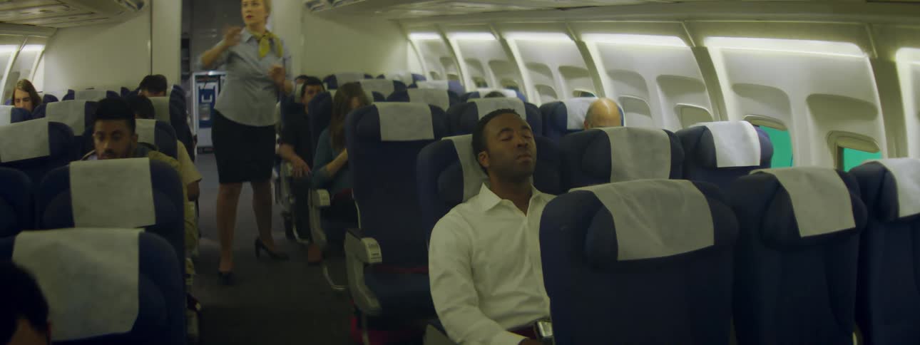 Stewardess closes overhead bins in an aircraft