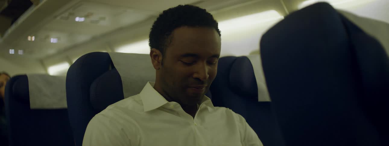 A man in an airplane looks around