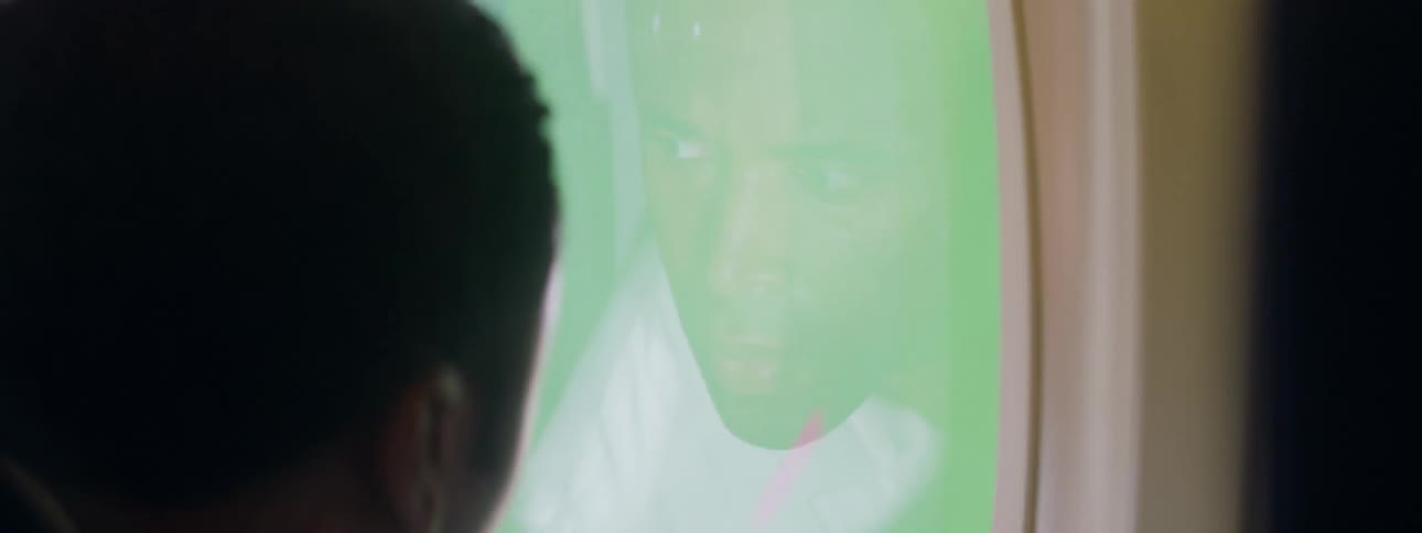 A man is nervously looking out an airplane window