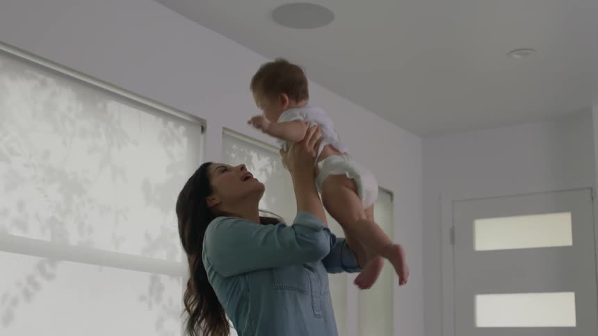 A woman plays with an infant