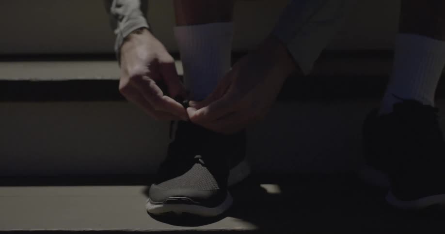 Man is tying his shoelaces
