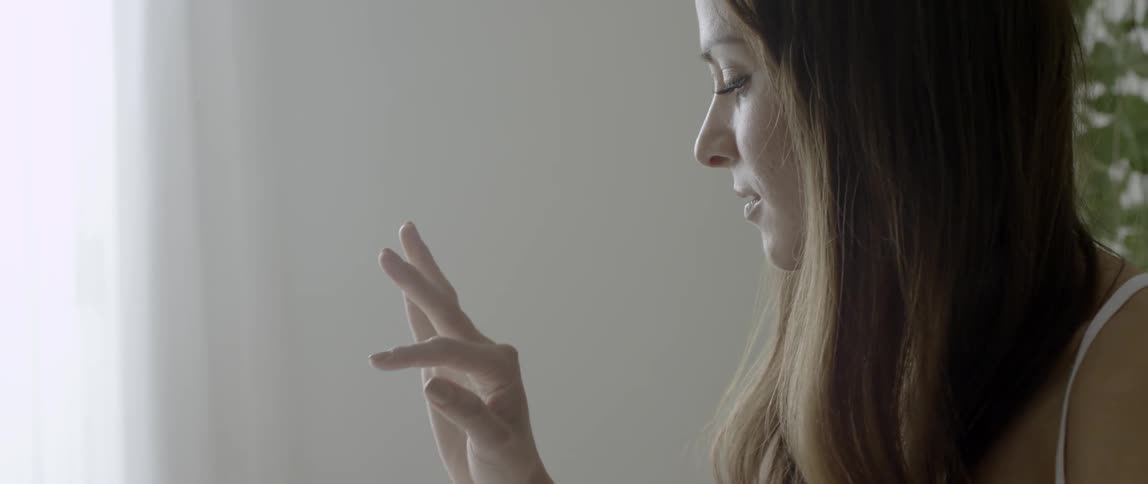 A woman is looking at her hands
