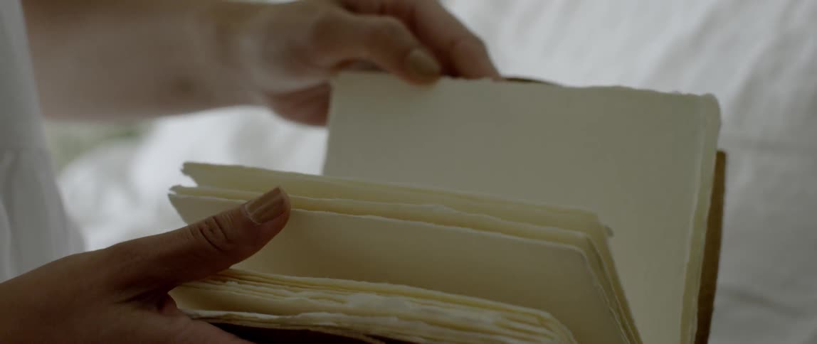 Person flips through pages of a blank book