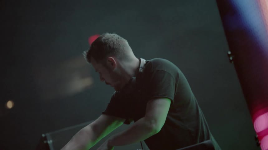 A man is performing on stage playing music