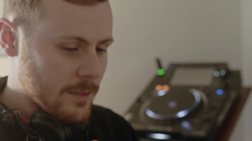 A dj is working in his studio