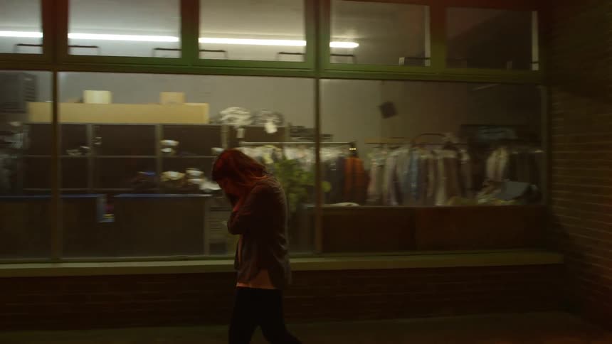 A woman is pacing outside of a business