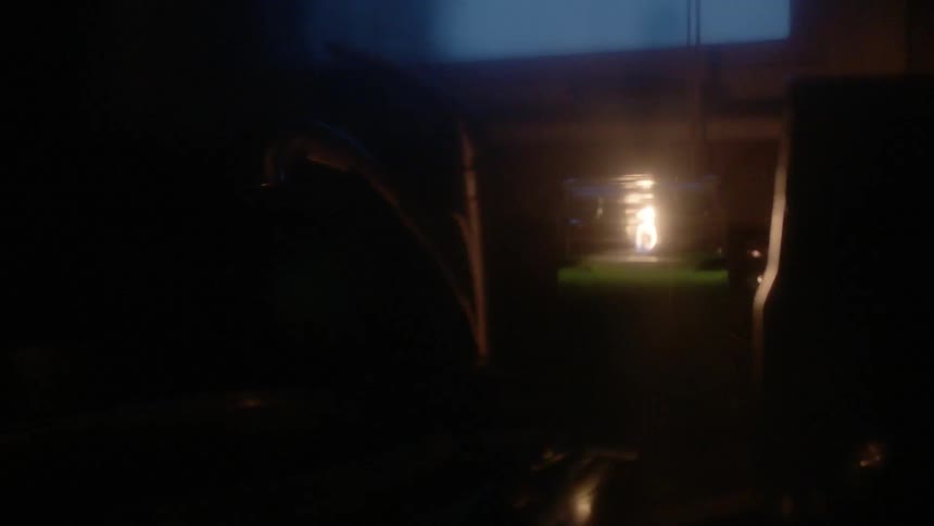 A small green candle burns in the room