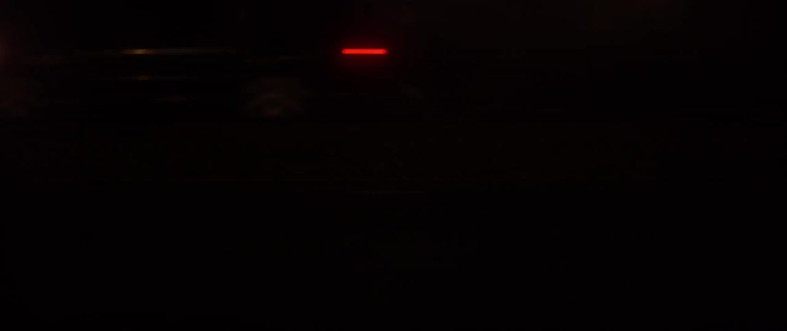 Cars are passing by the camera at night