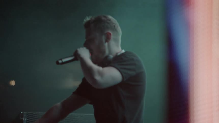 A dj performs for an audience