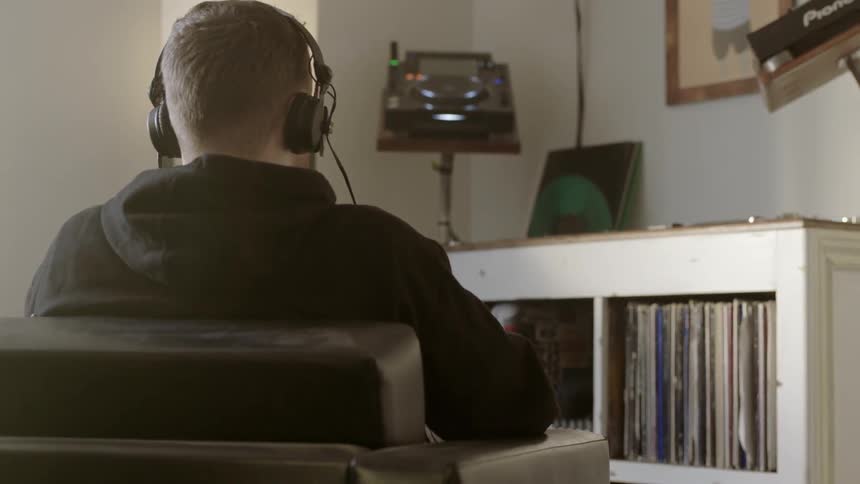 Man wearing headphones sitting in a chair