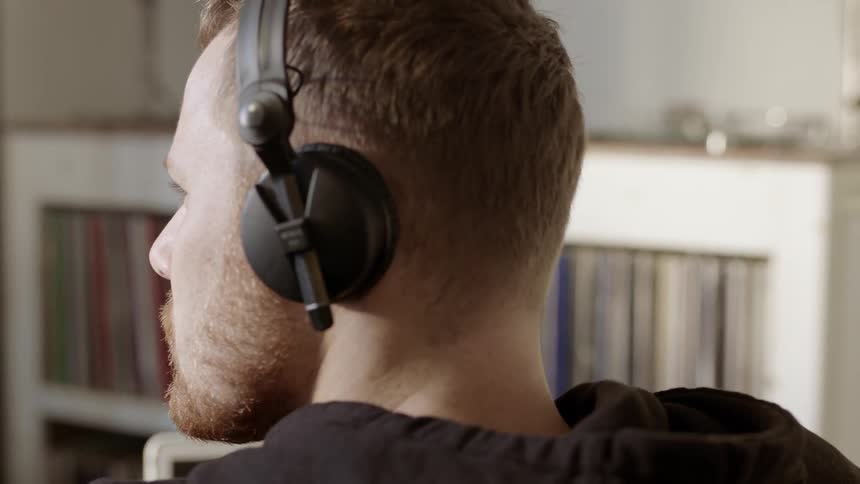 A man is bobbing his head as he listens to music