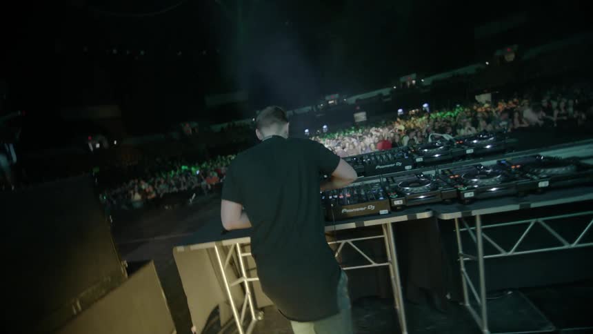 A man plays music on a stage at a  concert