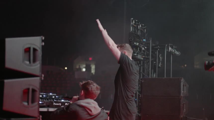 A musician claps and salutes the crowd