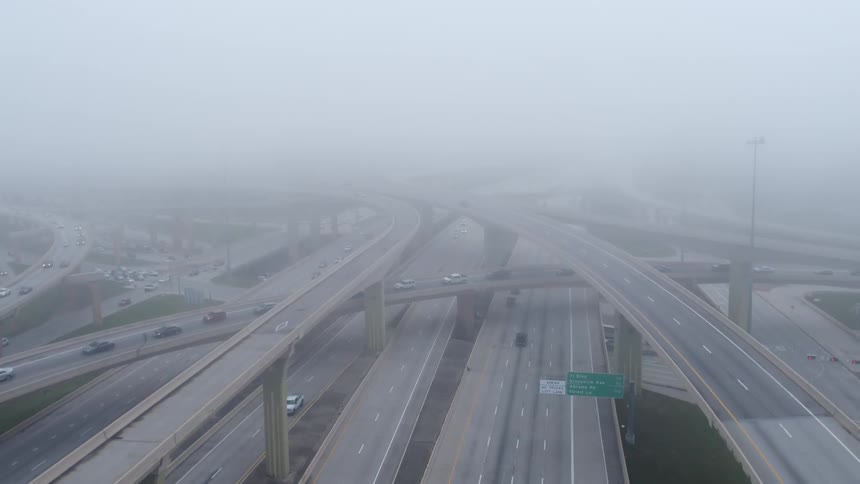 The highway below is covered in a very dense fog