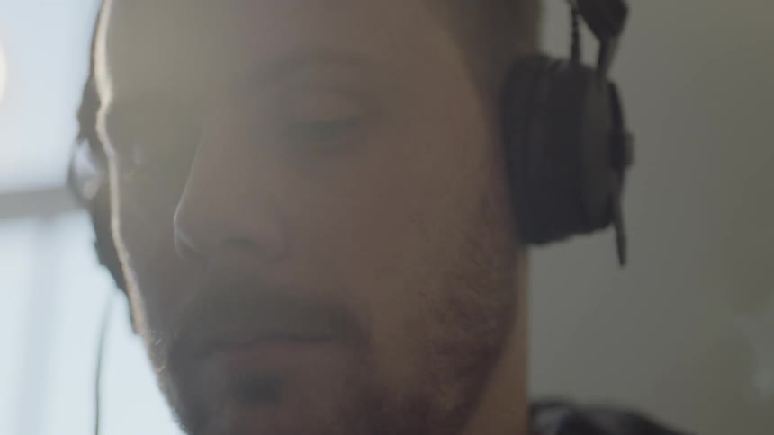 A man listens to music and bobs his head