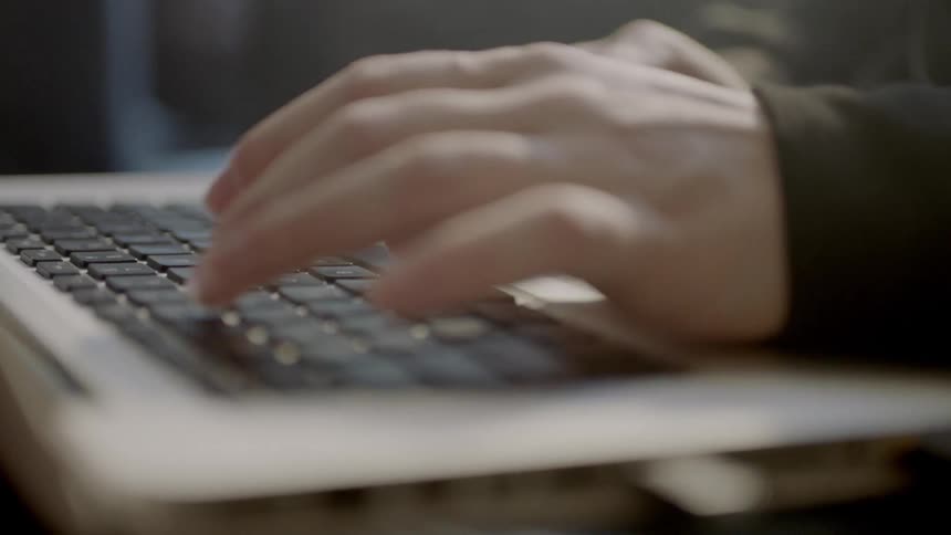 A person is typing on a keyboard