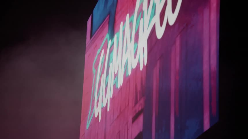 A billboard displays a logo