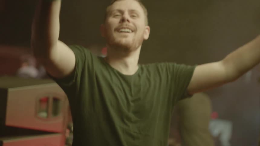 Bearded man sticks his tongue out and moves his arms around