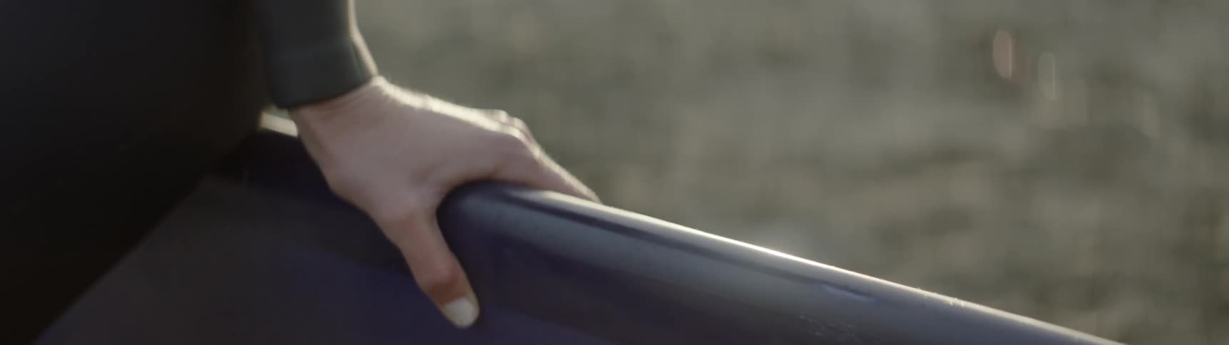 A person is holding onto a handrail