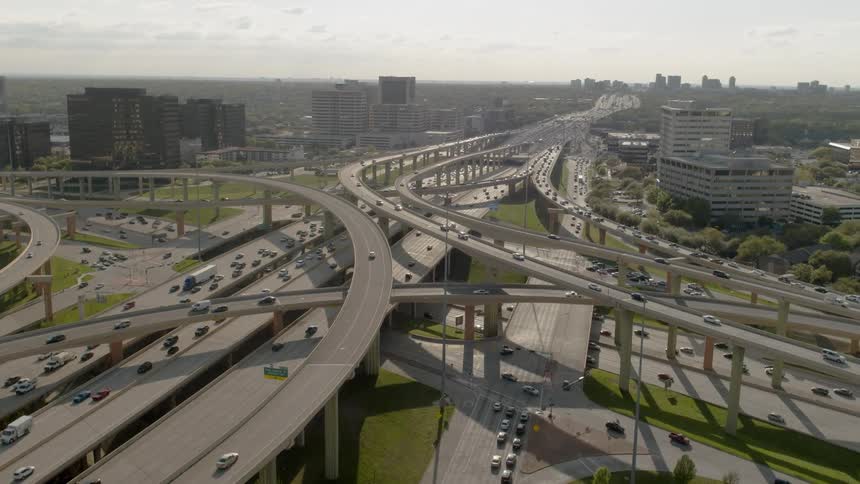 A busy expressway system is being filmed from a drone