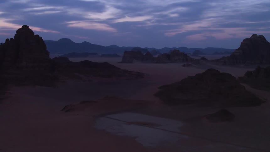 Mountains sit under a night sky