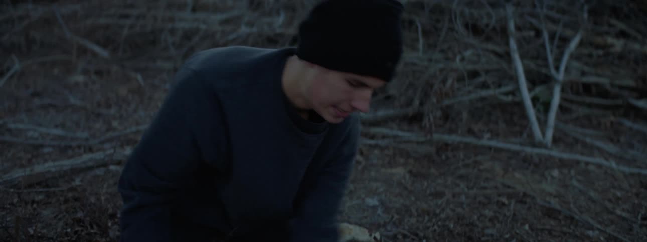 A man is digging through the dirt with his hands