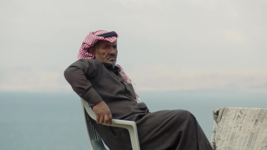 A man is sitting in a chair leaning back