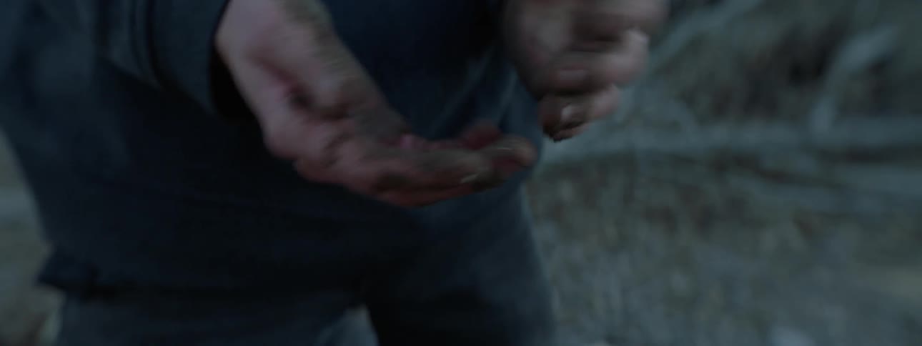 A man wipes his dirty hands together