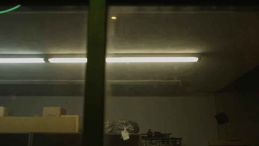 Lights illuminate the inside of a laundromat at night