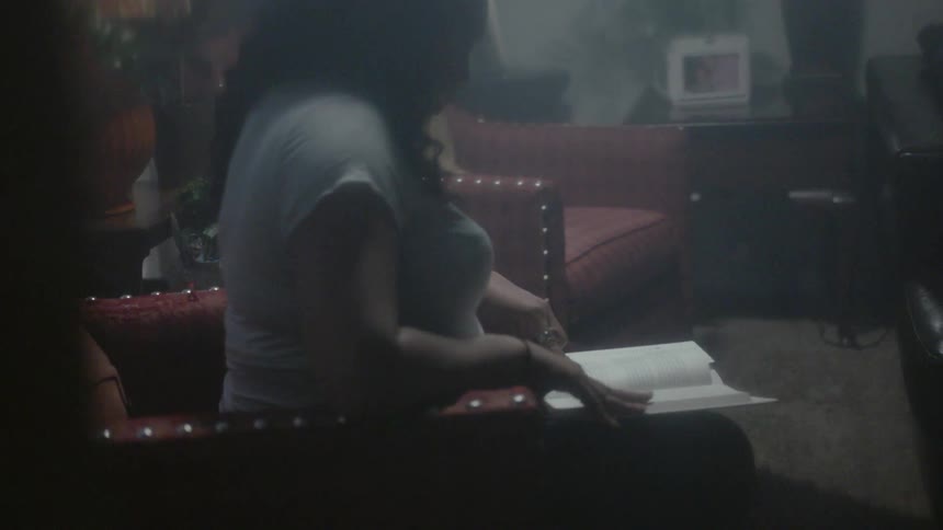 Woman sits in a chair reading a book