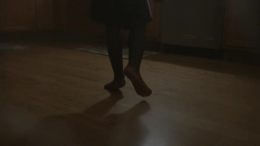 A child walks across the kitchen floor