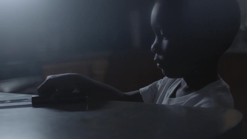 A child picks up a large knife from a counter