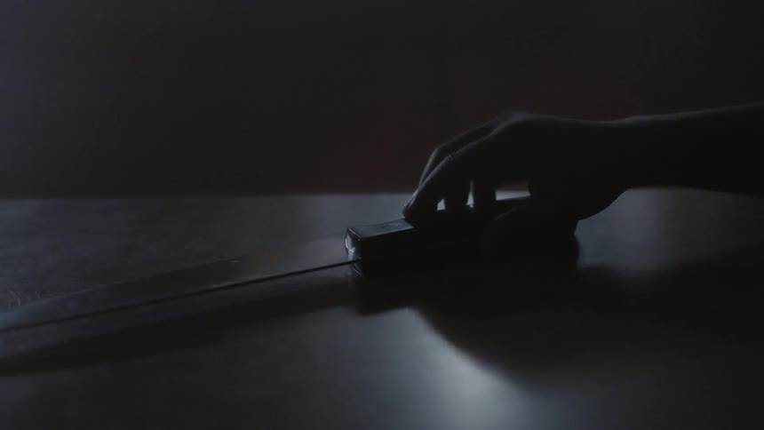 A child picks up a large knife